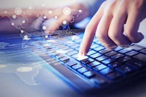 Hands of a young man on the keyboard with the elements. Collagel.